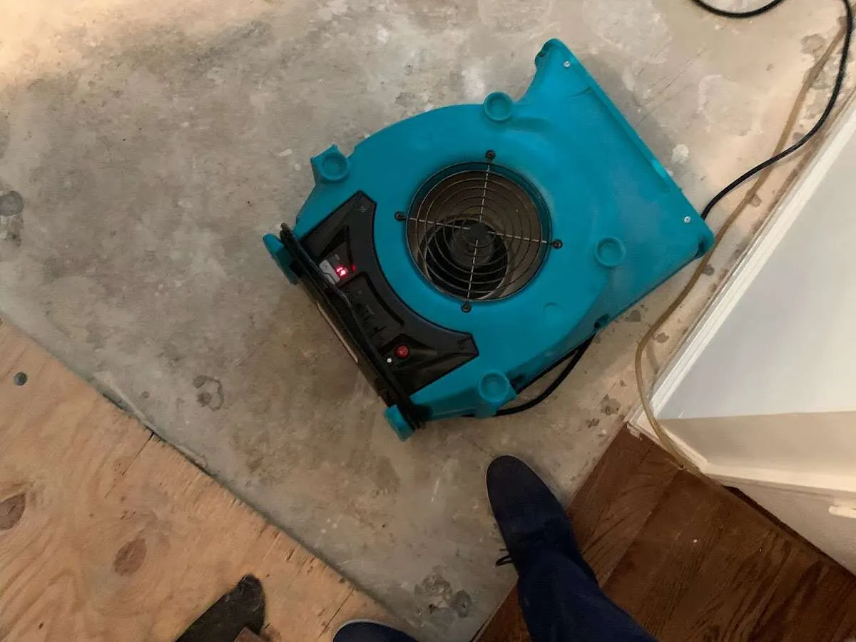 Air mover drying subfloor during Commercial Water Damage Restoration in Lake Charles